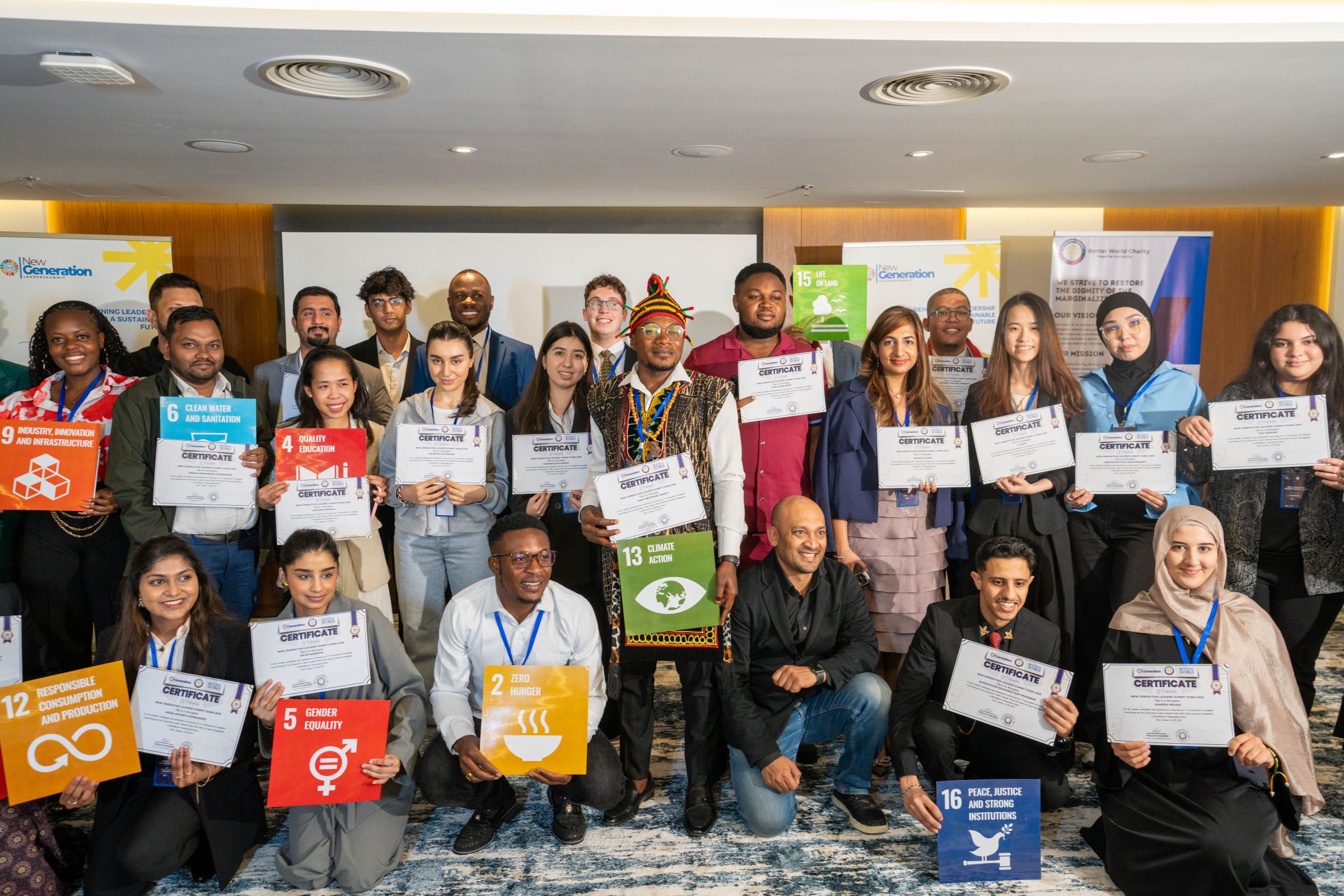 Delegates of the 2025 summit holding their certificates and Sustainable Development Goal cards